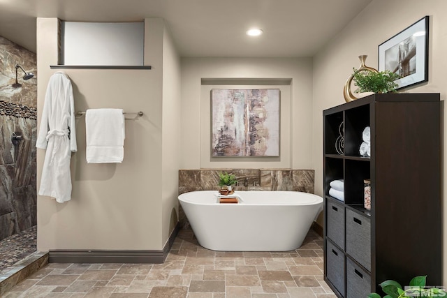 4840 Keshmiri Pl, Reno, NV 89519 - bathroom with a freestanding tub, a walk in shower, stone tile flooring, recessed lighting, and tile walls