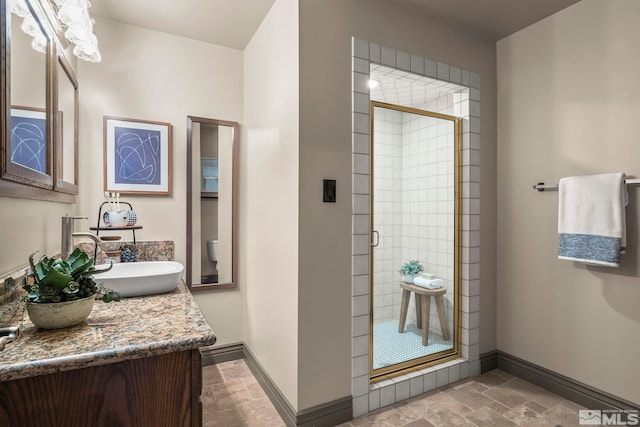 4840 Keshmiri Pl, Reno, NV 89519 - full bath with baseboards, stone tile flooring, a shower stall, and vanity