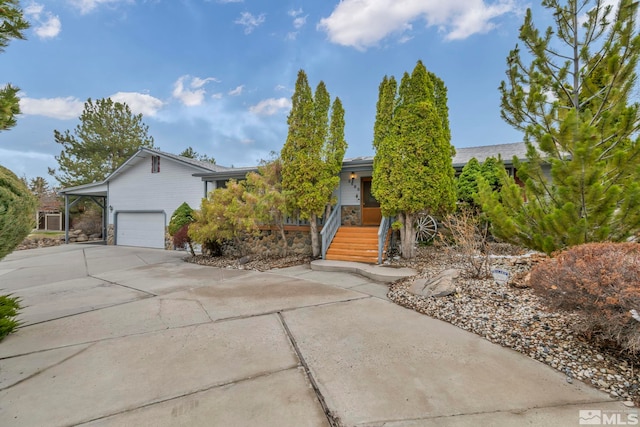 2080 Rock Haven Dr, Reno, NV 89511 - view of property hidden behind natural elements featuring driveway, a garage, and stone siding