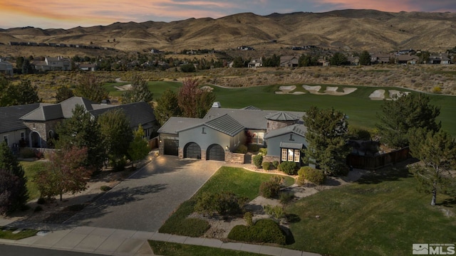 aerial view of property and surrounding area with a mountainous background and a golf club