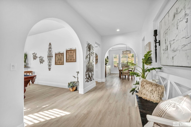 entrance foyer featuring arched walkways, wood finished floors, recessed lighting, baseboards, and pool table