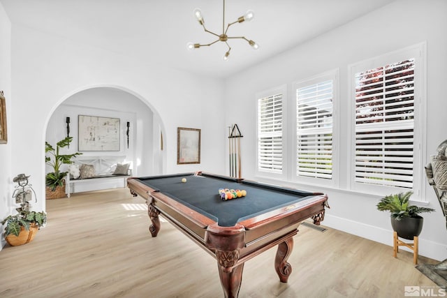 playroom with arched walkways, light wood-type flooring, a chandelier, pool table, and baseboards