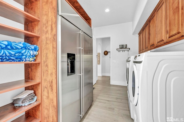 clothes washing area with cabinet space, independent washer and dryer, light wood-style floors, baseboards, and recessed lighting