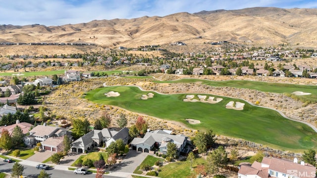 aerial view of property's location with nearby suburban area, mountains, and a golf course