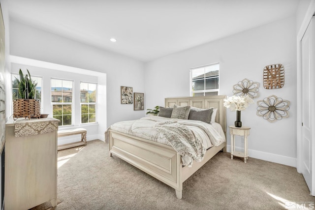 carpeted bedroom with multiple windows, baseboards, and recessed lighting
