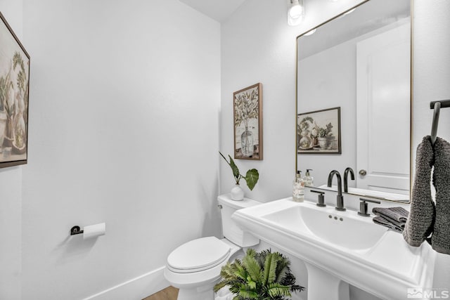 bathroom with toilet and a sink