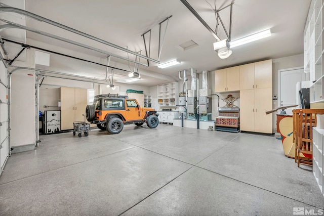 garage with a garage door opener and heating unit