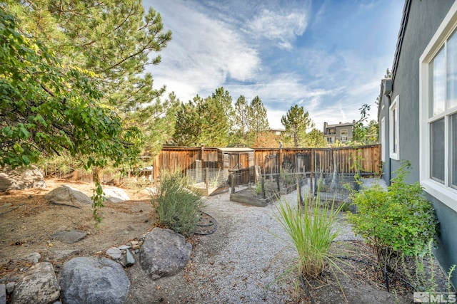 fenced backyard with a garden