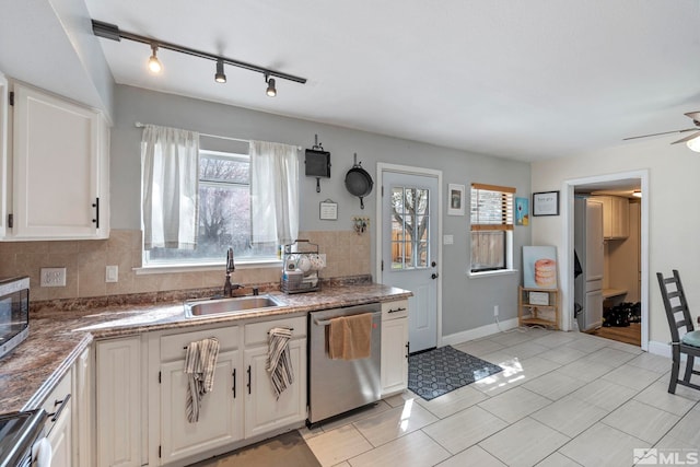 11 E P St, Sparks, NV 89431 - kitchen with stainless steel appliances, a sink, rail lighting, white cabinets, and backsplash