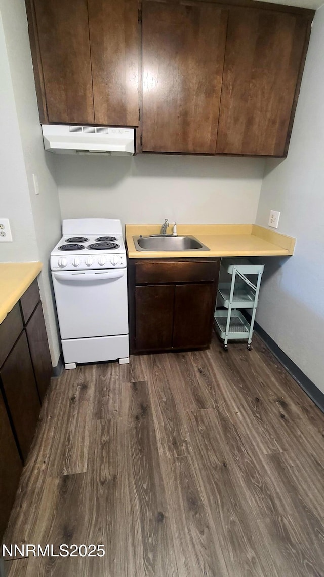 2450 Lymbery St Unit 118, Reno, NV 89509 - kitchen with white range with electric cooktop, under cabinet range hood, dark wood-style flooring, dark brown cabinets, and light countertops