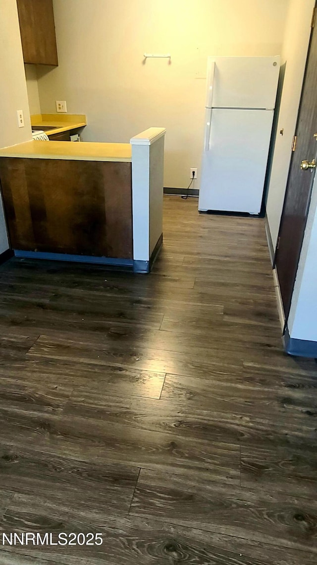 2450 Lymbery St Unit 118, Reno, NV 89509 - kitchen featuring dark wood-style flooring, freestanding refrigerator, a peninsula, and light countertops