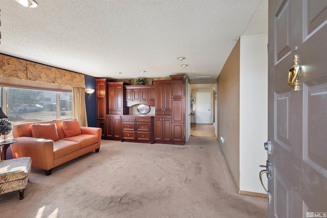 living room featuring light colored carpet, baseboards, and a textured ceiling