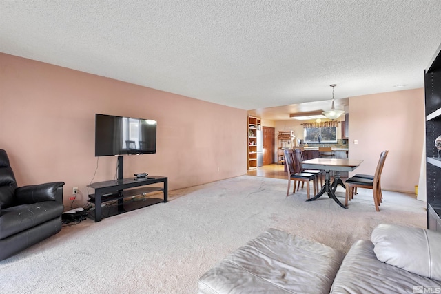 living room with light carpet and a textured ceiling