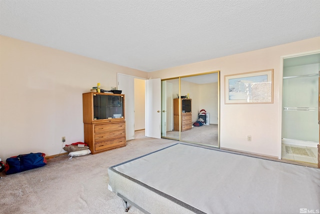 unfurnished bedroom with carpet flooring, a closet, baseboards, and a textured ceiling