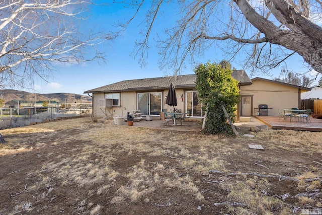 back of property featuring a deck and a fenced backyard