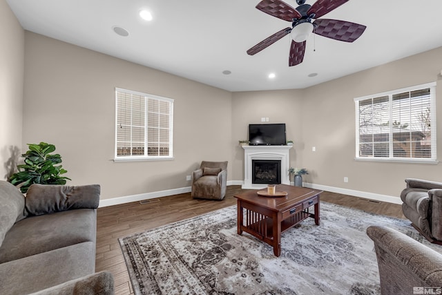 5807 Desert Mirage Dr, Sparks, NV 89436 - living area with wood finished floors, ceiling fan, a glass covered fireplace, baseboards, and recessed lighting