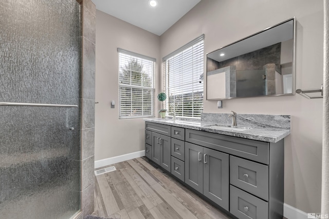 5807 Desert Mirage Dr, Sparks, NV 89436 - full bathroom with double vanity, wood finished floors, a shower stall, baseboards, and recessed lighting
