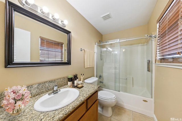 5765 Vista Serena Way Unit 103, Sparks, NV 89436 - bathroom featuring tile patterned floors, toilet, vanity, and combined bath / shower with glass door