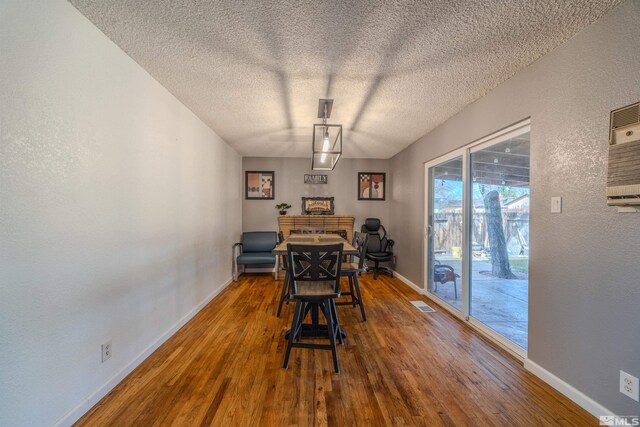 250 Galleron Way, Sparks, NV 89431 - dining room with a textured ceiling, baseboards, wood finished floors, a textured wall, and a fireplace