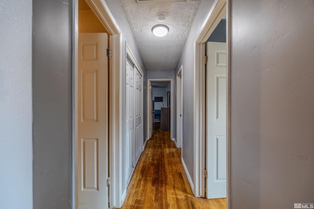 250 Galleron Way, Sparks, NV 89431 - hallway with a textured ceiling, wood finished floors, and baseboards
