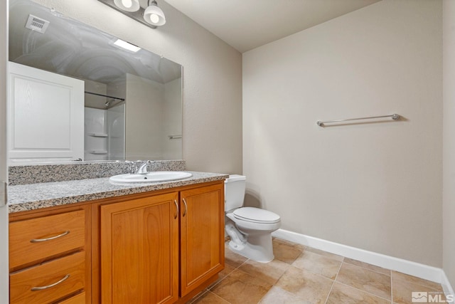 4817 Bougainvillea Cir, Sparks, NV 89436 - bathroom featuring toilet, vanity, baseboards, a shower, and tile patterned floors