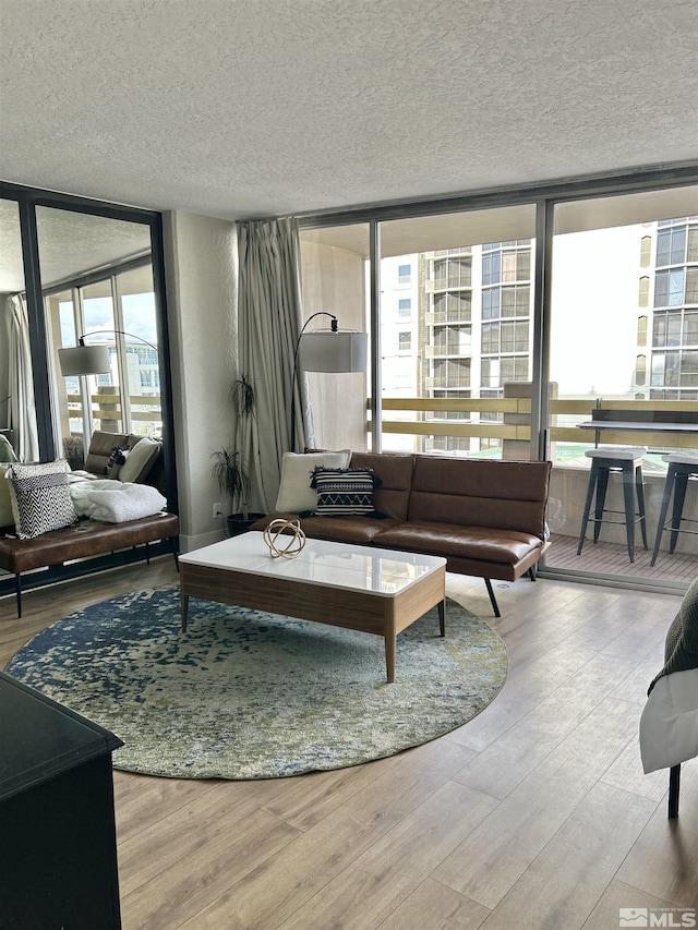 100 N Arlington Ave Unit 8C, Reno, NV 89501 - living area featuring a wall of windows, a textured ceiling, and wood finished floors