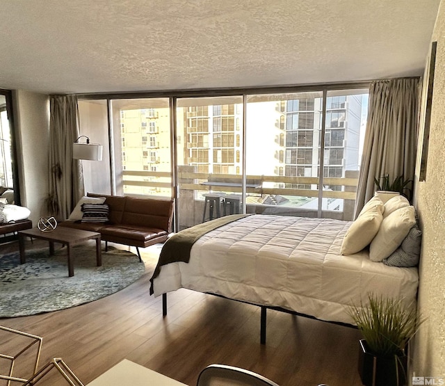 100 N Arlington Ave Unit 8C, Reno, NV 89501 - bedroom with a textured ceiling and wood finished floors
