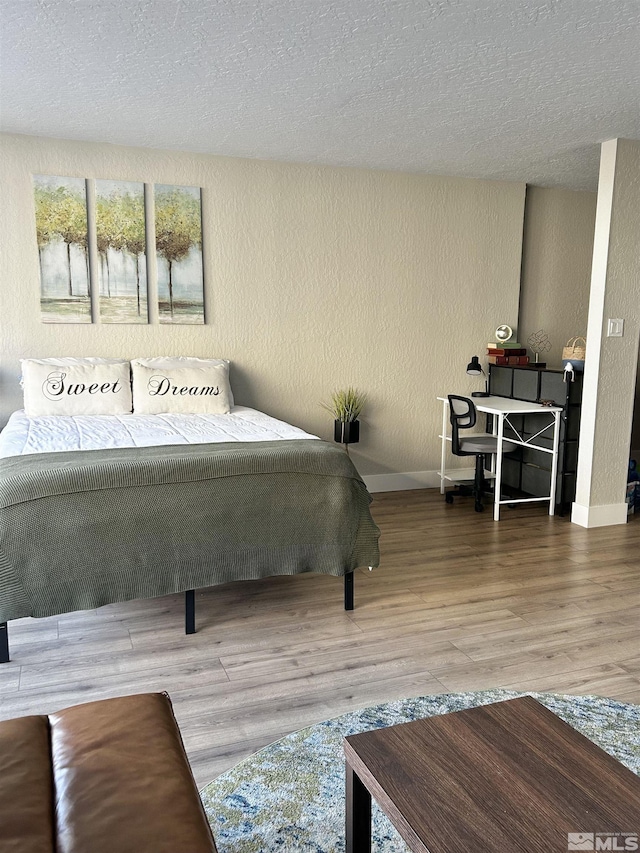 100 N Arlington Ave Unit 8C, Reno, NV 89501 - living area with wood finished floors, a textured ceiling, baseboards, and a textured wall