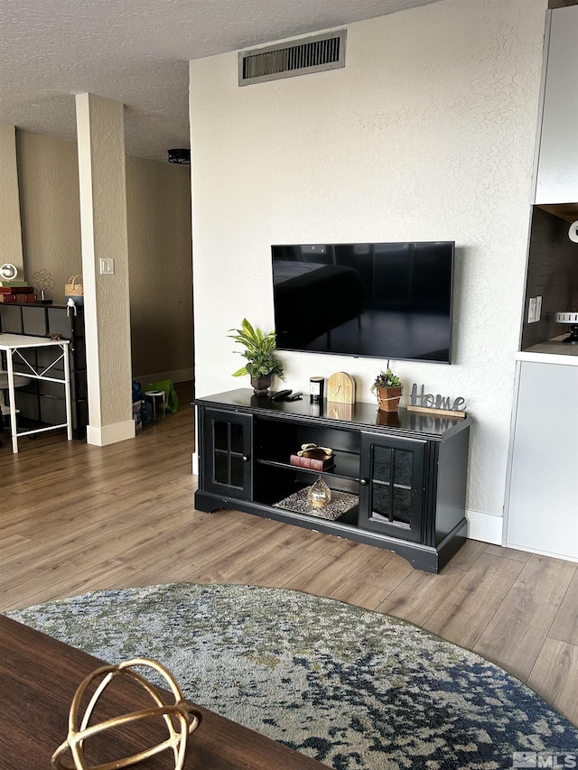 100 N Arlington Ave Unit 8C, Reno, NV 89501 - living area featuring wood finished floors, baseboards, and a textured wall