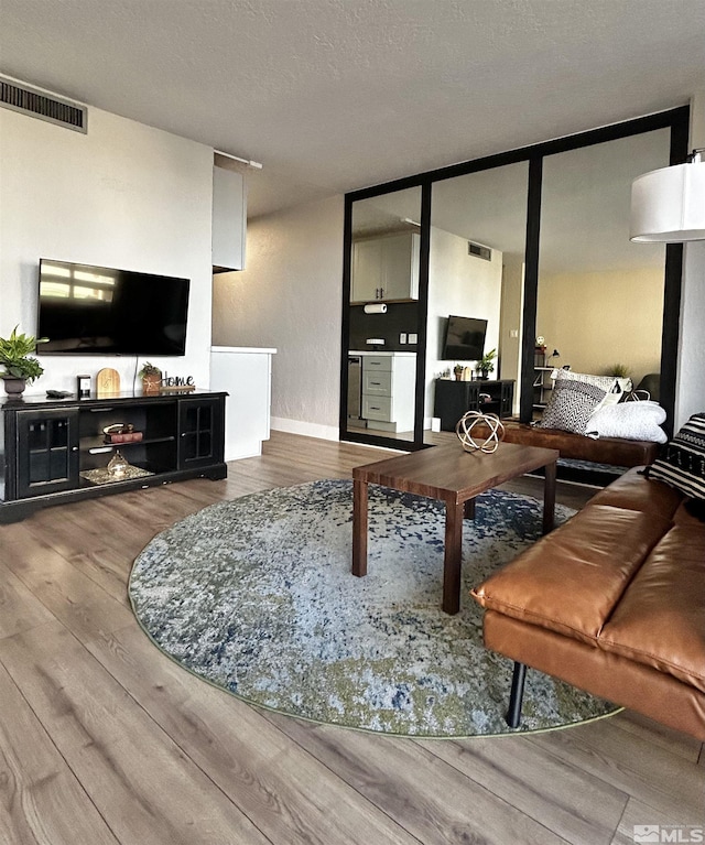 100 N Arlington Ave Unit 8C, Reno, NV 89501 - living area with wood finished floors, a textured ceiling, and baseboards