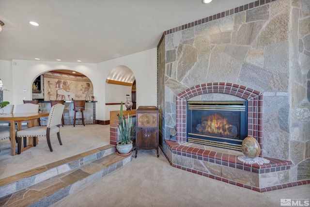15 Hidden Lake Dr, Reno, NV 89521 - carpeted living room with a tile fireplace, recessed lighting, baseboards, and arched walkways
