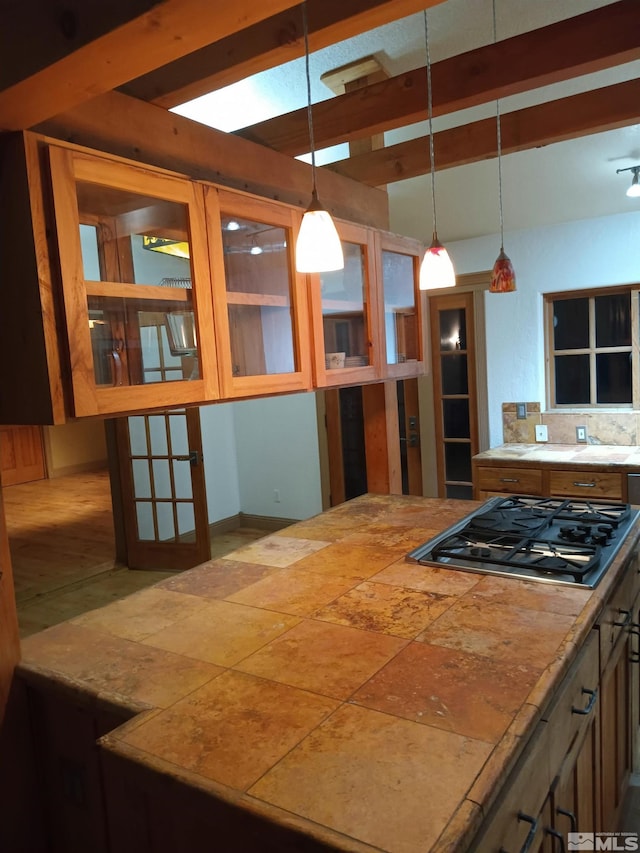 21410 Sazarac Rd, Reno, NV 89521 - kitchen featuring stainless steel gas cooktop, hanging light fixtures, and glass insert cabinets