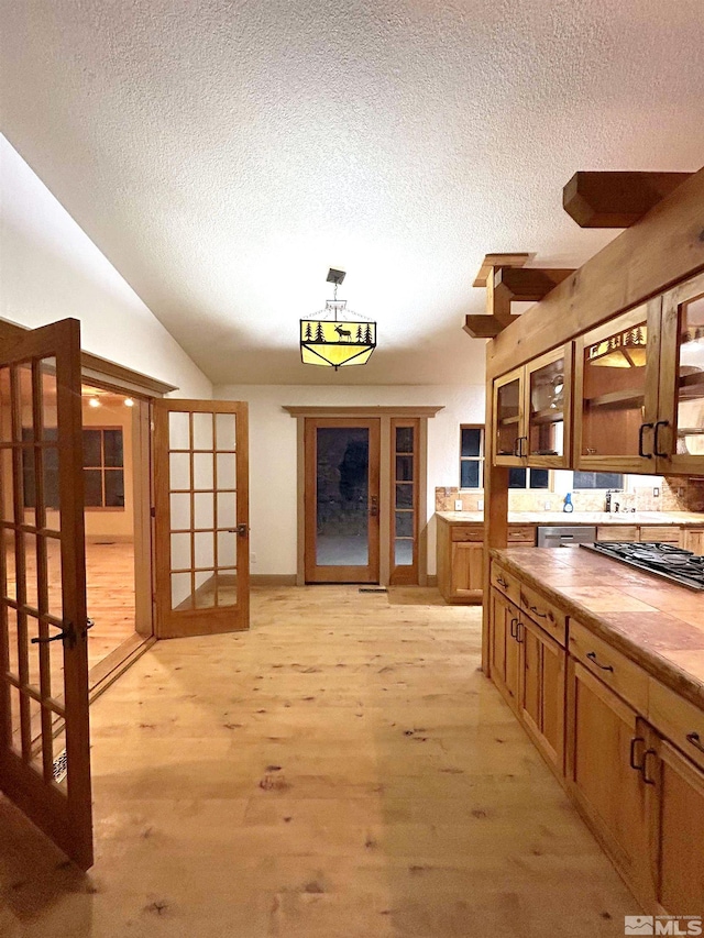 21410 Sazarac Rd, Reno, NV 89521 - hallway with a textured ceiling, light wood-style floors, vaulted ceiling, and french doors