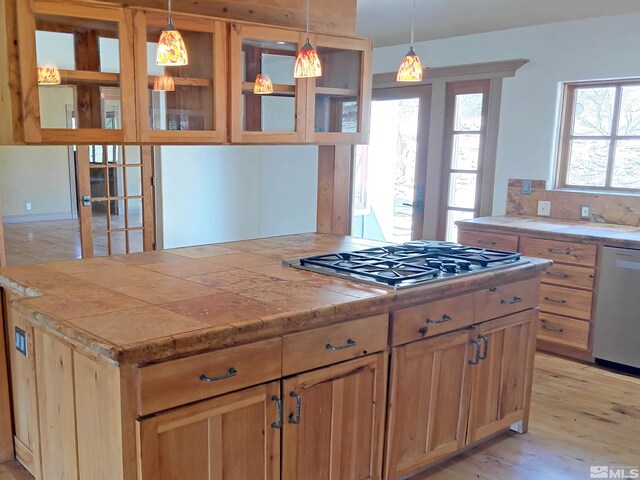 21410 Sazarac Rd, Reno, NV 89521 - kitchen featuring appliances with stainless steel finishes, light wood finished floors, a kitchen island, and hanging light fixtures
