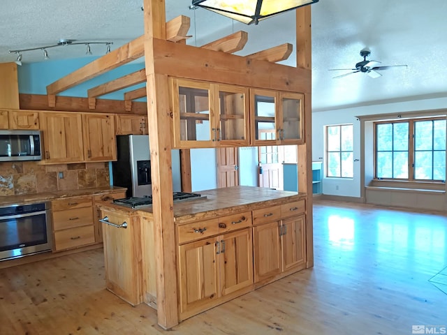 21410 Sazarac Rd, Reno, NV 89521 - kitchen with stainless steel appliances, light wood-type flooring, backsplash, a textured ceiling, and light brown cabinets