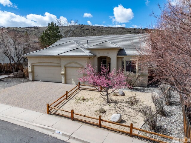 159 River Flow Dr, Reno, NV 89523 - view of front of house with stucco siding, an attached garage, fence, and driveway