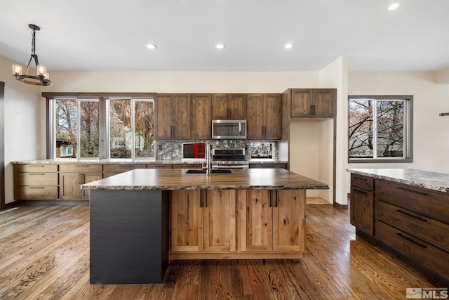 159 River Flow Dr, Reno, NV 89523 - kitchen featuring appliances with stainless steel finishes, plenty of natural light, wood finished floors, and recessed lighting