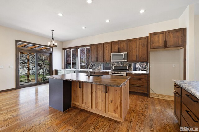 159 River Flow Dr, Reno, NV 89523 - kitchen featuring appliances with stainless steel finishes, a sink, wood finished floors, backsplash, and recessed lighting