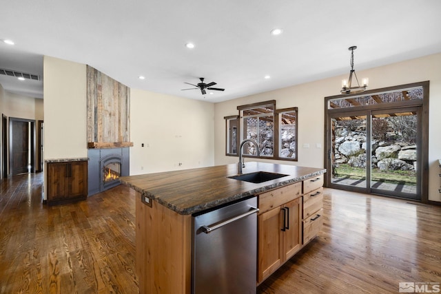 159 River Flow Dr, Reno, NV 89523 - kitchen with a sink, stainless steel dishwasher, a fireplace, dark wood-type flooring, and recessed lighting