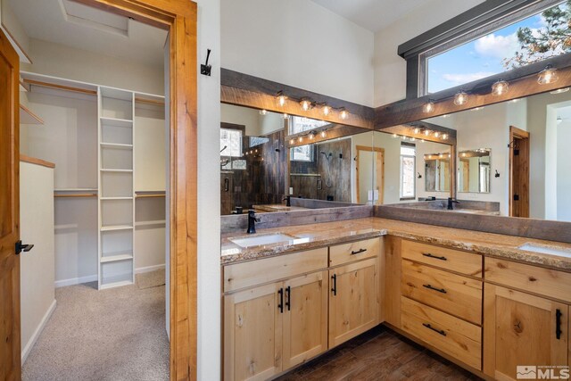 159 River Flow Dr, Reno, NV 89523 - full bath featuring double vanity, a walk in closet, a shower, and baseboards