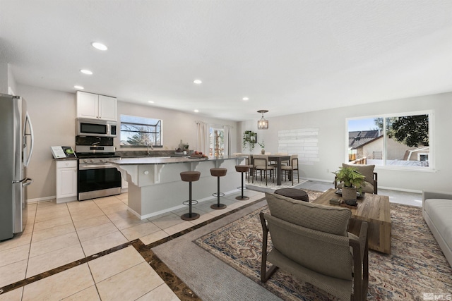 1599 Lucerne, Minden, NV 89423 - living area with recessed lighting, baseboards, light tile patterned floors, and inlaid floor details