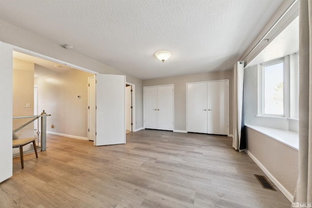 1599 Lucerne, Minden, NV 89423 - spare room featuring baseboards, light wood-style flooring, a smoke detector, and a textured ceiling