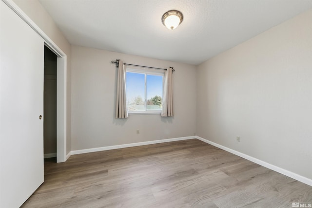 1599 Lucerne, Minden, NV 89423 - unfurnished bedroom with light wood-style floors, baseboards, and a closet