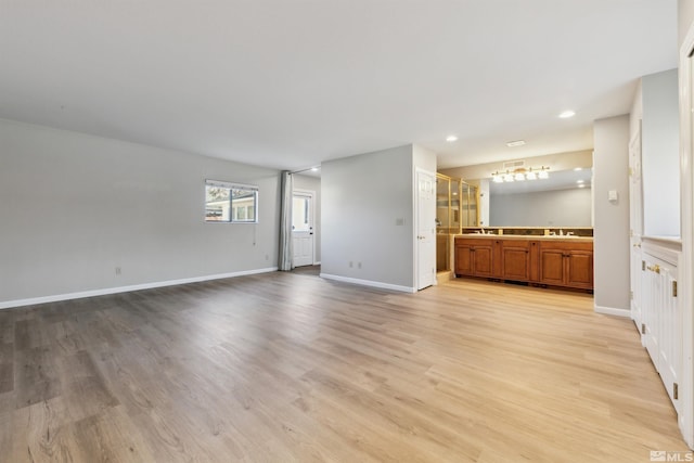 1599 Lucerne, Minden, NV 89423 - unfurnished living room with light wood-style floors, baseboards, and recessed lighting