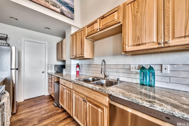 245 Tramway Dr, Stateline, NV 89449 - kitchen featuring stainless steel appliances, a sink, backsplash, light wood-style flooring, and light stone counters