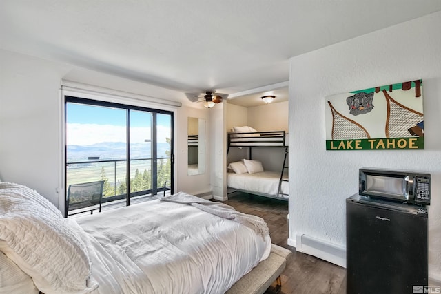 245 Tramway Dr, Stateline, NV 89449 - bedroom with a baseboard heating unit, wood finished floors, baseboards, and fridge