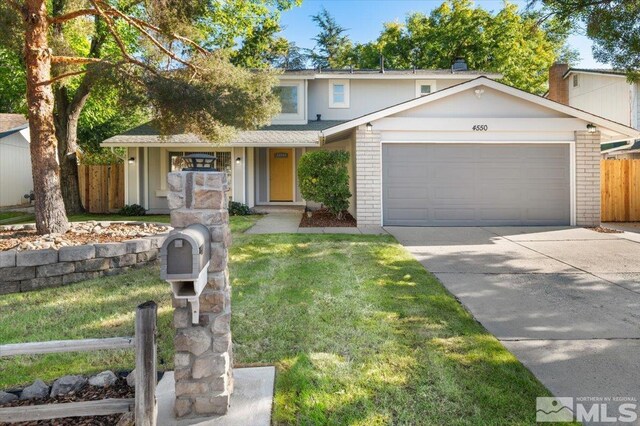 4550 Noche Ln, Reno, NV 89502 - traditional-style home featuring brick siding, an attached garage, and driveway