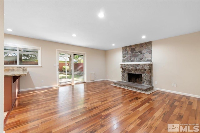 4550 Noche Ln, Reno, NV 89502 - unfurnished living room featuring light wood-type flooring, a fireplace, recessed lighting, and baseboards
