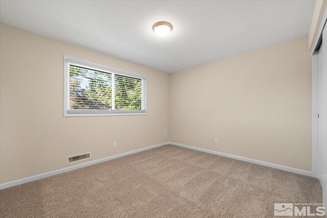 4550 Noche Ln, Reno, NV 89502 - empty room with light carpet and baseboards