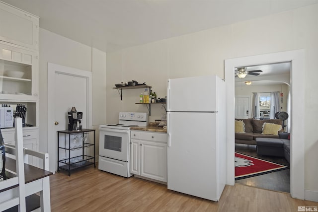 529 11th St, Sparks, NV 89431 - kitchen with white appliances, open shelves, light wood finished floors, white cabinets, and ceiling fan